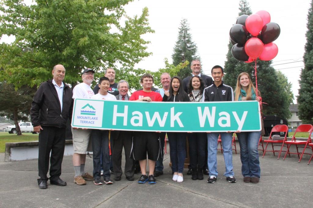 Michelle Schomer
The ASB officers and city officials gather for a photo with the Hawk Way sign on Sept. 26. 
