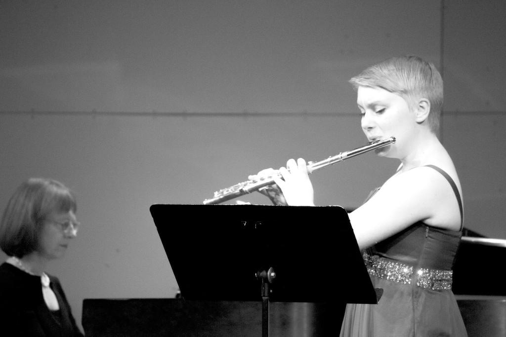 Lucy Schermer (right) performs a piece at her senior flute recital on May 9 at the MTHS Theater, accompanied by pianist Kristine Anderson (left).