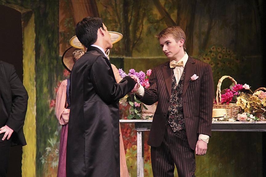 Jack Worthing (played by Matthew Sythandone) reluctantly shakes hands with Algernon Moncrieff (played by Tyler Grabarczyk).