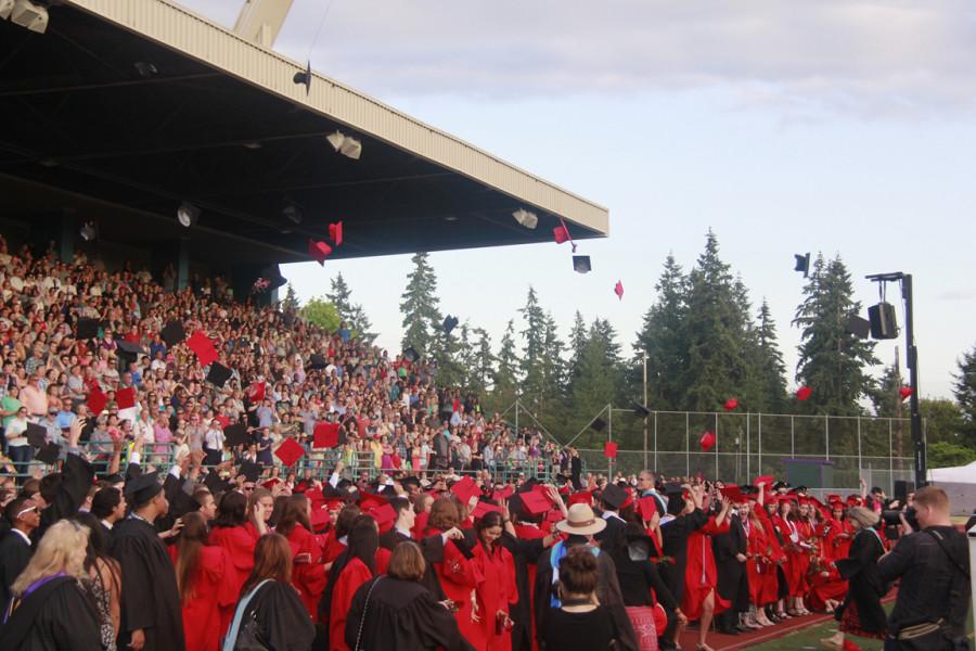 Graduates throw their caps in the air after the final speech of their graduation ceremony.