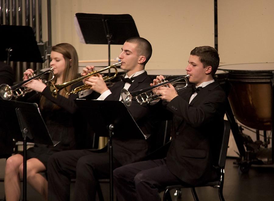 Group of trumpets preforming with chamber winds.