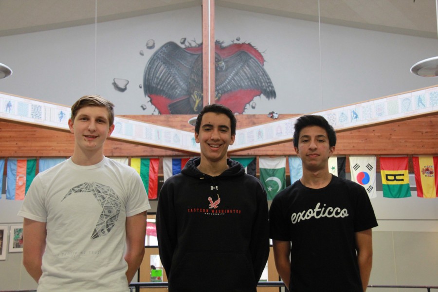 Juniors Samuel Polevoy (left), Malek Qibba (center) and Bukhari Shakil (right) pose in their Exoticco shirts at the front of the school.