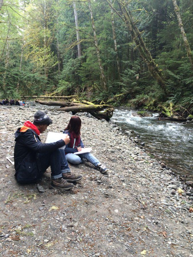 Junior Isaac Otis (left) and senior Jessica Phung (right) learn how to measure sediment type beside Barnes Creek.