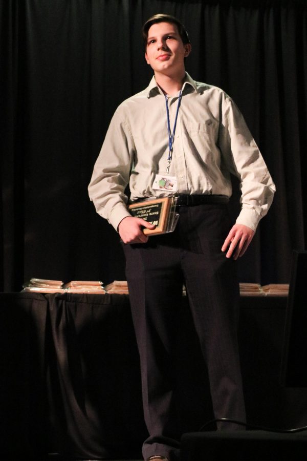 Sophomore Dior Nazarov holds his plaque with pride as he places 3rd in the Transportation Modeling event.