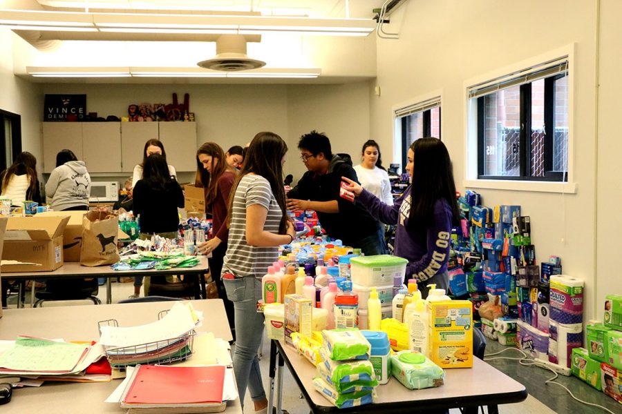 Key Club moves their collected items into separate categories that will later be divided into bags for homeless shelters.