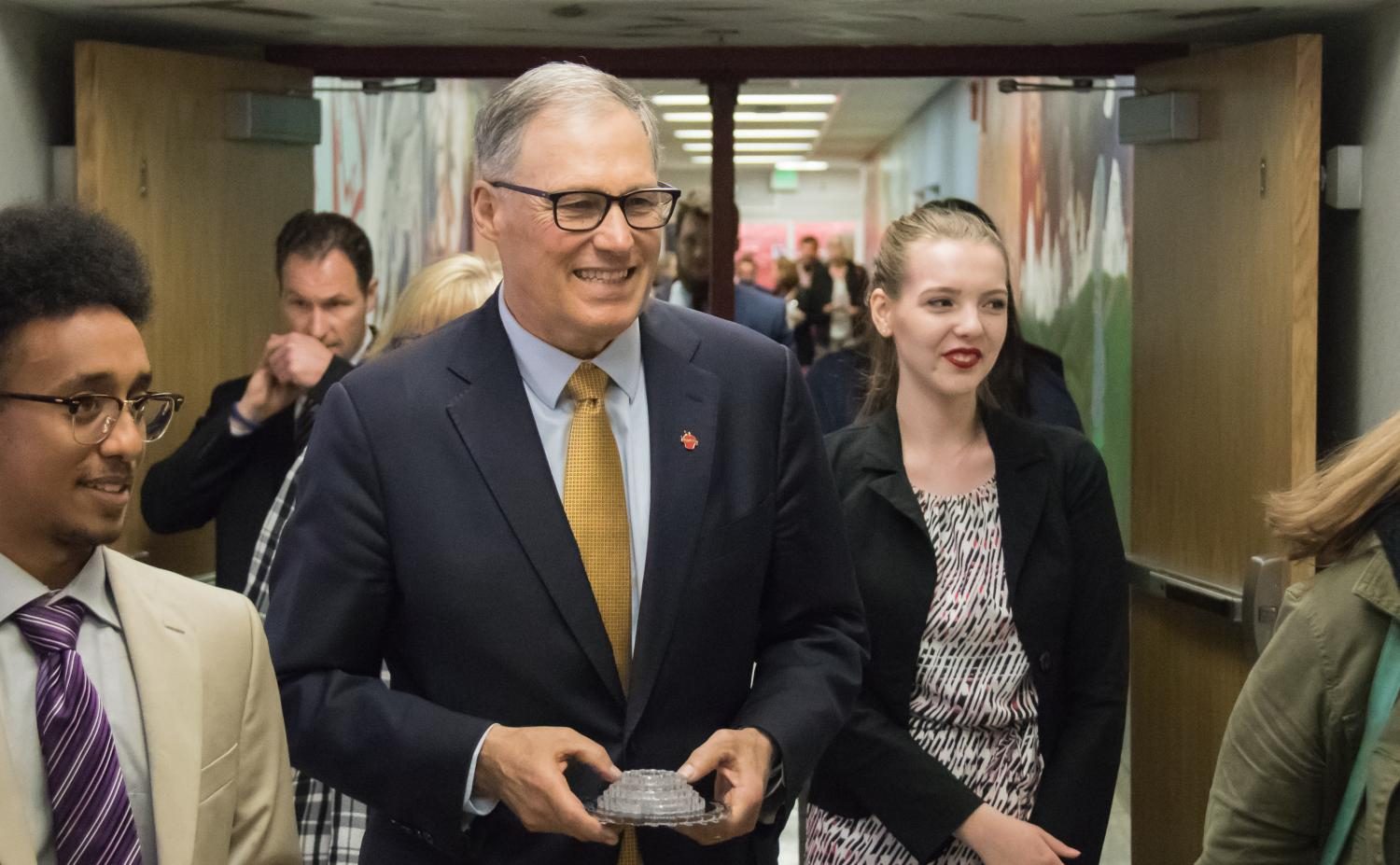 Governor Inslee exits the Art and Technology wing accompanied by seniors Elizabeth Jurgensen and Natu Abraham.