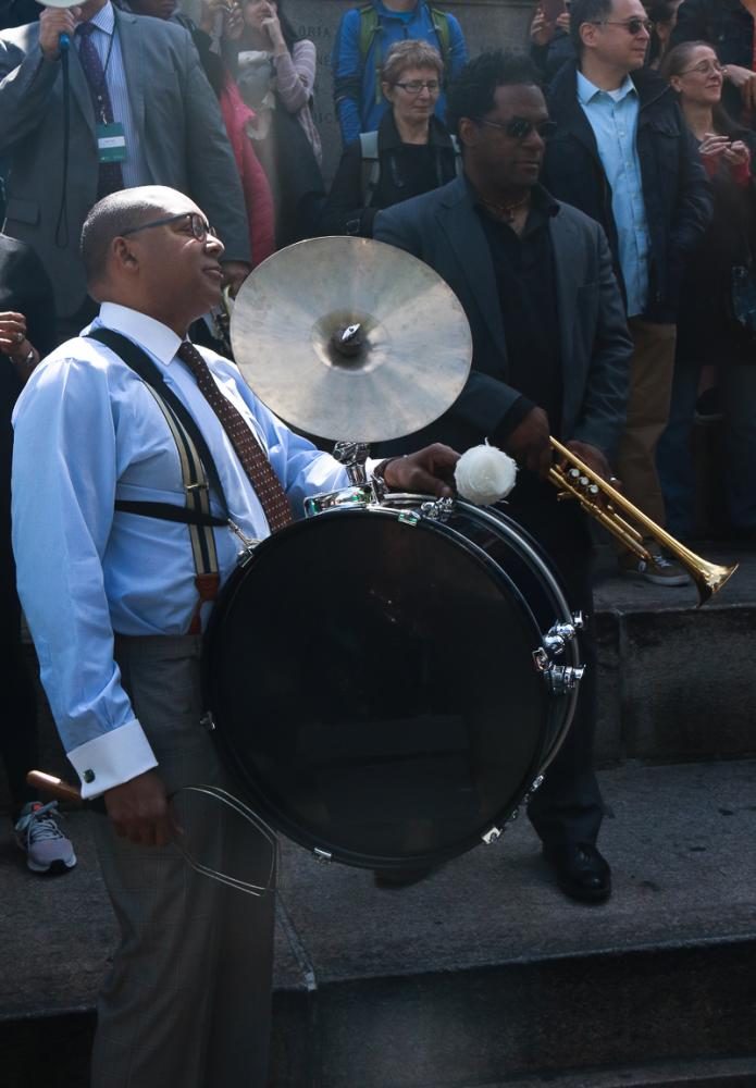 Wynton Marsalis begins the parade on the bass drum with trumpet player Marcus Printup in the center of Columbus Circle.