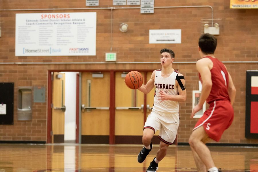 Junior Point Guard Mason Christianson Brings the ball up the court and starts the Terrace offense. 