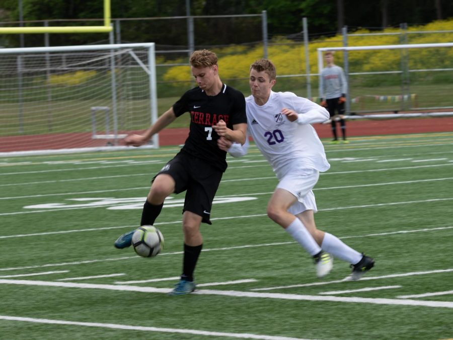 Just about to pass, senior Kevin Broulette is bumped into by Anacortes  freshman Aidan Pinson.