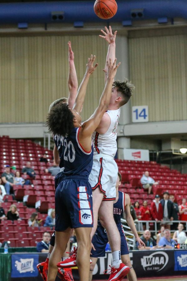 Junior post Jace Breakfield makes a hook shot over two Black Hills players, Weston Ainsworth (24) and Justin Hicks (20).