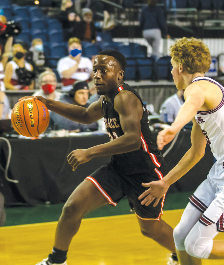 Senior guard Jeffrey Anyimah drives against Mt. Spokane at the Tacoma Dome. The Hawks finished the tournament with a 6th place trophy.