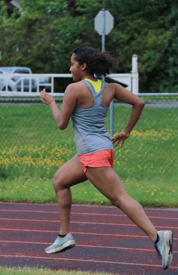 Another shot of Damaris Ibrahim running on the track from a side angle.