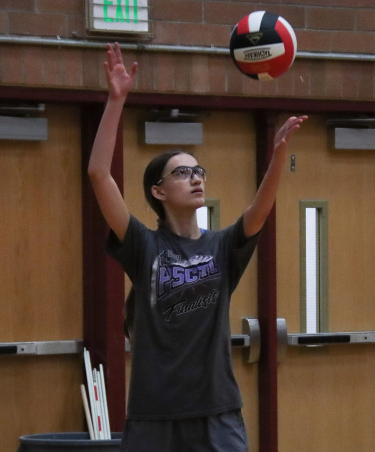 Sophia Pigott serves the ball during tryouts two weeks ago for her second year of volleyball.