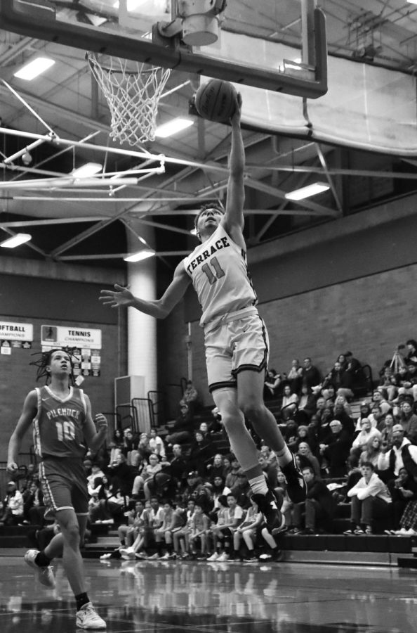 Senior guard Chris Meegan drives to the basket in regular season game against Marysville-Pilchuck Dec. 6 in the Terraceum. The Hawks thumped the Tomahawks 71-35