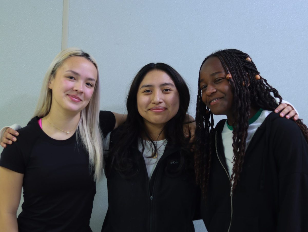 Penelope Kim, Neela Lopez Hernandez, and Rosechelle Obare pose for a picture.