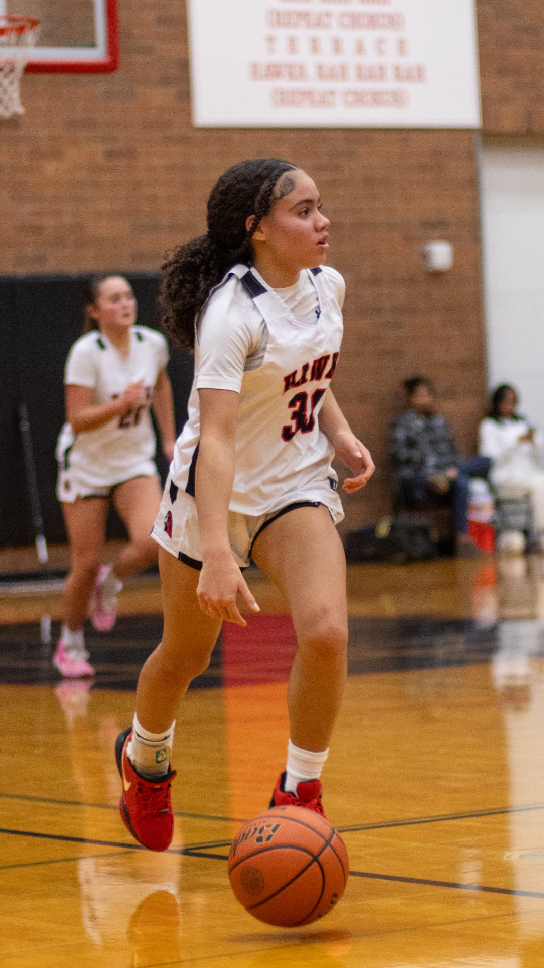 Freshman Jaliyah Dyson runs the ball downcourt for the Hawks.